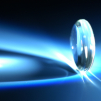 SCHOTT low Tg glass for precision molding in complex or aspherical lenses Lens on a blue background made from low Tg glass for precision molding