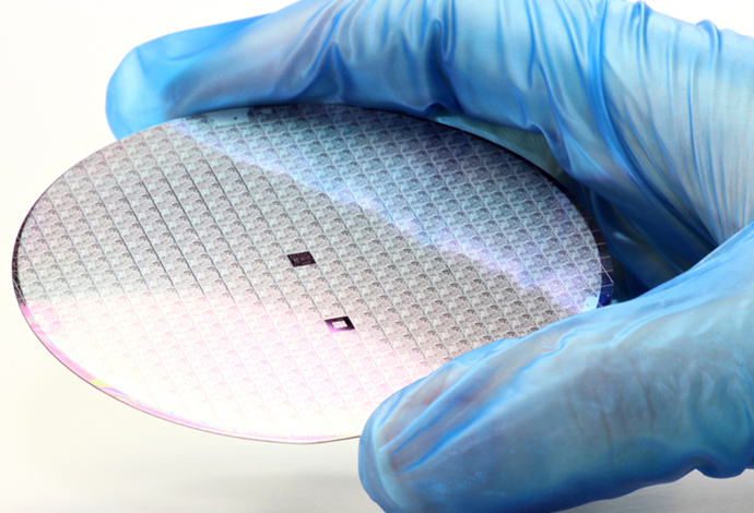 SCHOTT offers lead-free glass powders for wafer passivation Gloved hand holding a wafer