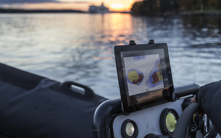 Navigation display on a boat in the middle of a river at sunrise