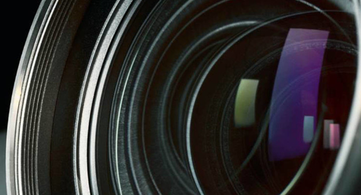 SCHOTT glass components for high-resolution imaging and projection Close up of a projector lens with reflected colors