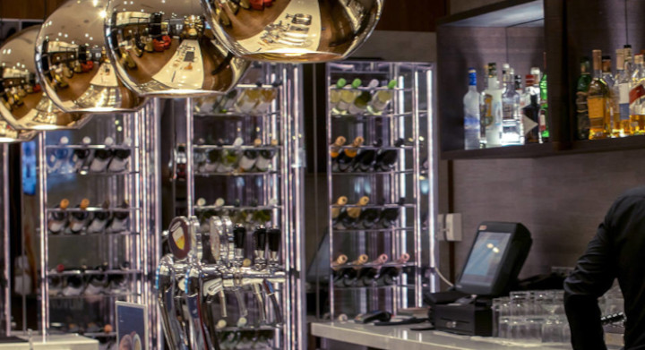 SCHOTT glass and glass-ceramic products are used in many areas of retail and gastronomy Luxury bar with barman and bottles