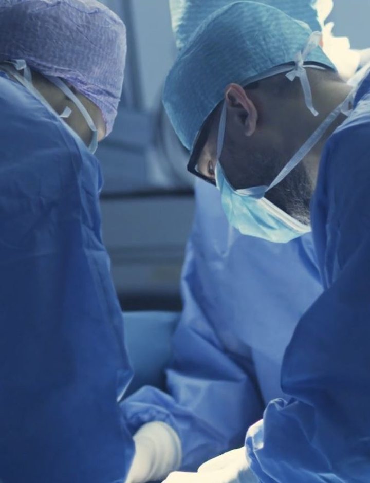 Three doctors working in a hospital operating theater